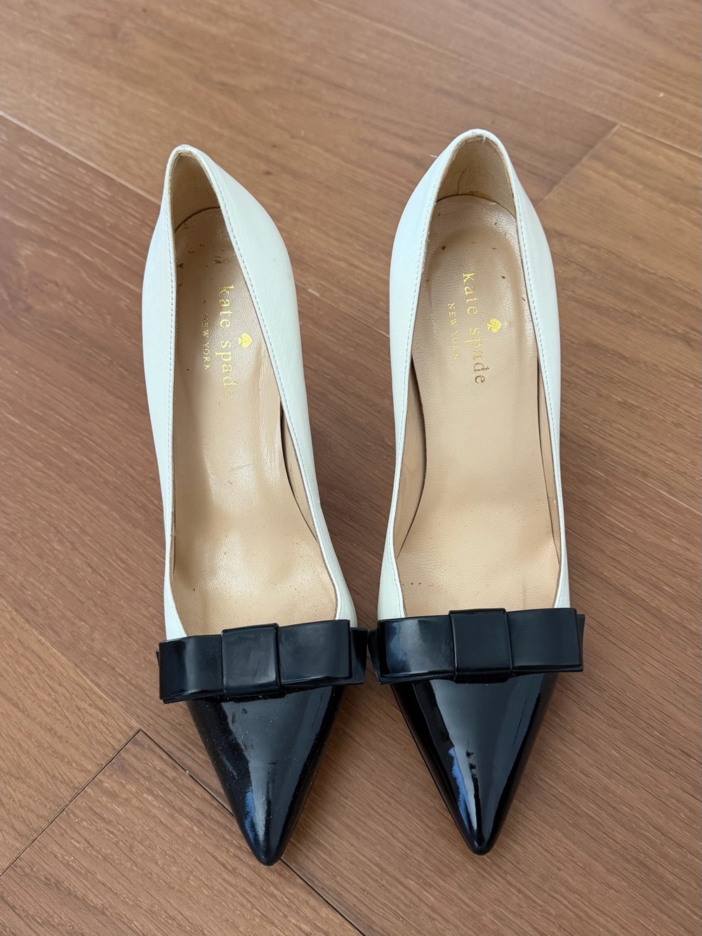 kate spade Ivory and Black Pointed-Toe Bow Pumps with Patent Toe